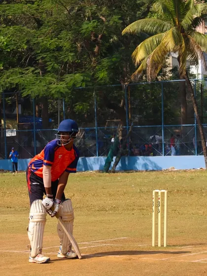 A young batsman focused at the crease during a preparation match for the Purushottam Shield Tournament.