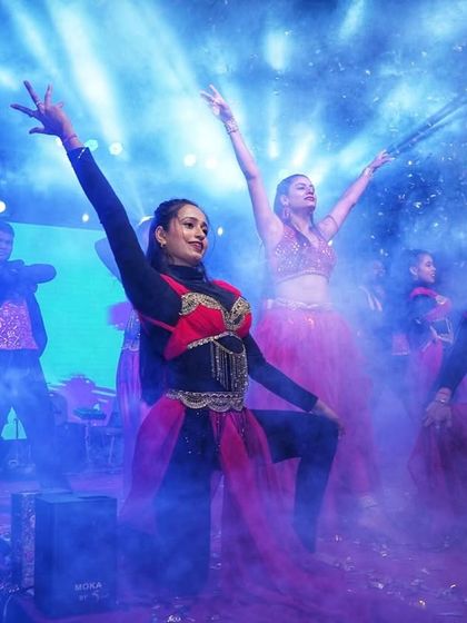 A shot of my dance troupe during a vibrant New Year's Eve performance. We created a festive atmosphere with synchronized moves, colorful costumes, and stage effects like smoke to energize the crowd.