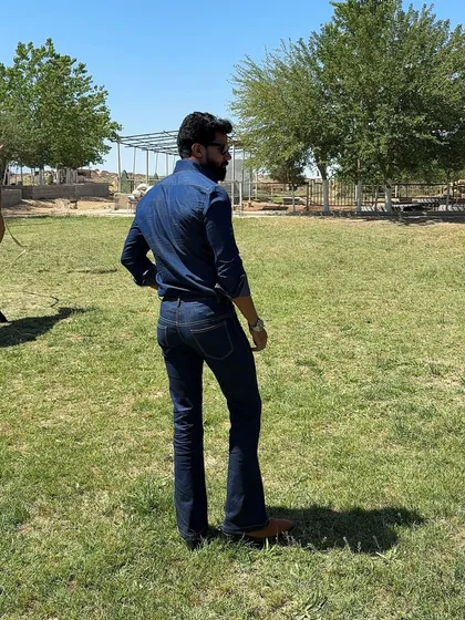 The back view of our denim ensemble, showcasing the perfect fit of the bootcut jeans and the shirt's tailored silhouette.