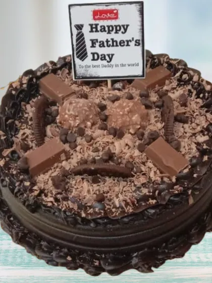 For the ultimate chocolate lover, this Father's Day chocolate overload cake is pure indulgence. It's a rich chocolate cake covered in chocolate shavings, Ferrero Rocher chocolates, and pieces of KitKat, creating a variety of textures and decadent flavors.
