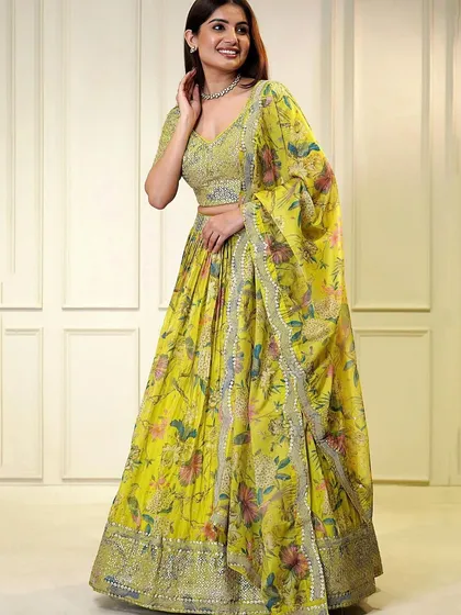 The perfect Haldi outfit. This yellow organza lehenga is bright, cheerful, and adorned with sequins to make you shine on your special day.