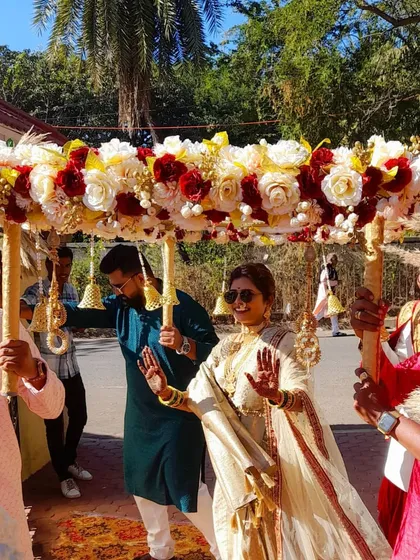 A happy bride dances her way in under a beautiful floral canopy. I can customize these rentals with any flower combination you like.