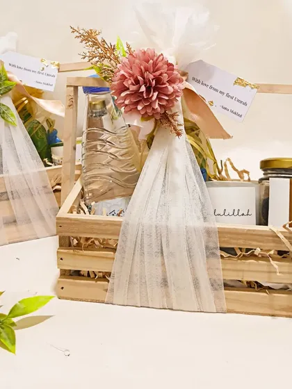 These wooden crate baskets were curated as Umrah return gifts for a special client, filled with Zamzam water, dates, and scented candles.