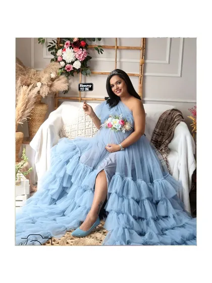 A sweet announcement with a "Mommy to be" prop. Her regal pose and tiara make her look like a true queen.