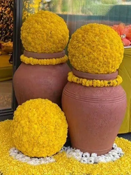 Traditional decor elements like these earthen pots adorned with marigold flower balls add an authentic and beautiful touch to any wedding function. We pay close attention to these small details.