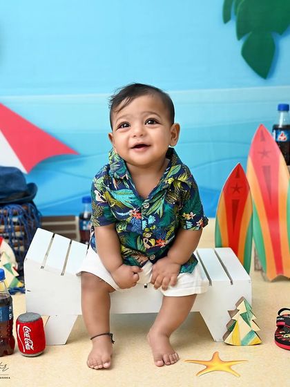 A happy beachgoer enjoying the sun. His bright smile and relaxed pose on the miniature beach bench make this a perfectly cheerful and fun-themed photo.