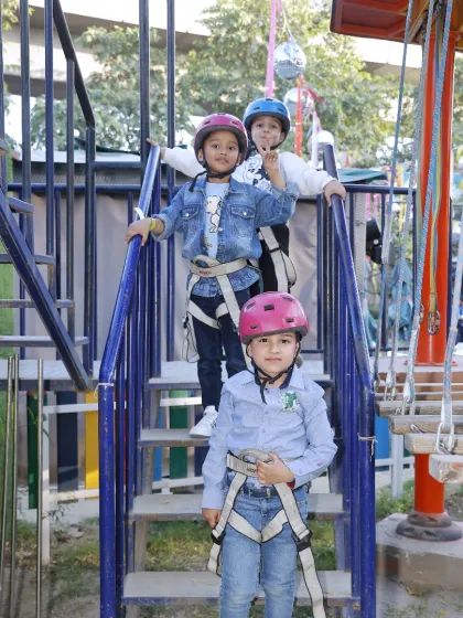 Safety first, then adventure! Here, our little explorers are fully harnessed and ready to take on the challenges of our multi-level high ropes course.