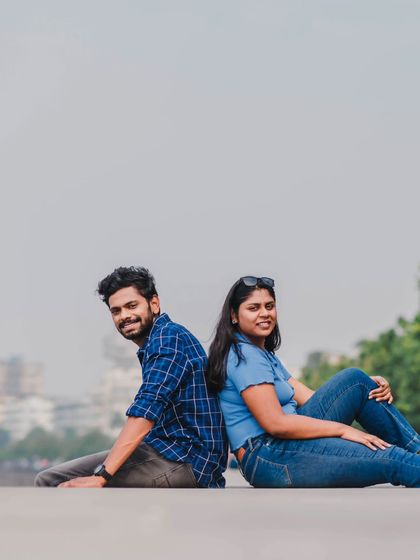 A relaxed, seated portrait of the couple looking at the camera, perfect for a casual Save the Date photo.