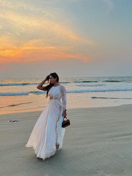 Walking on the beach in a flowy white saree, feeling the Bollywood magic. I love to fully embrace the theme of a destination wedding, both in my hosting and my style.