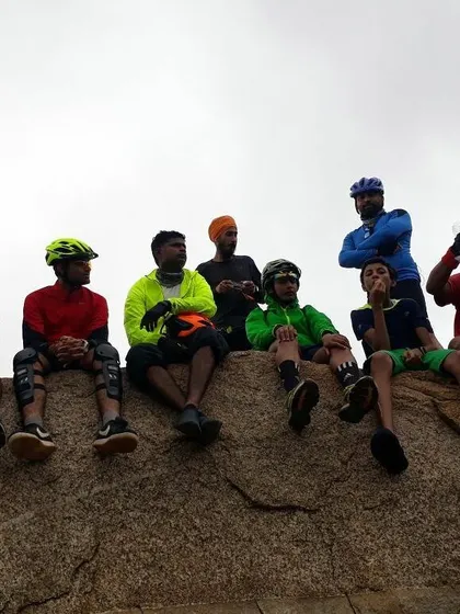 A candid shot of the group taking a break, with some members wearing knee pads for extra protection on the trails.