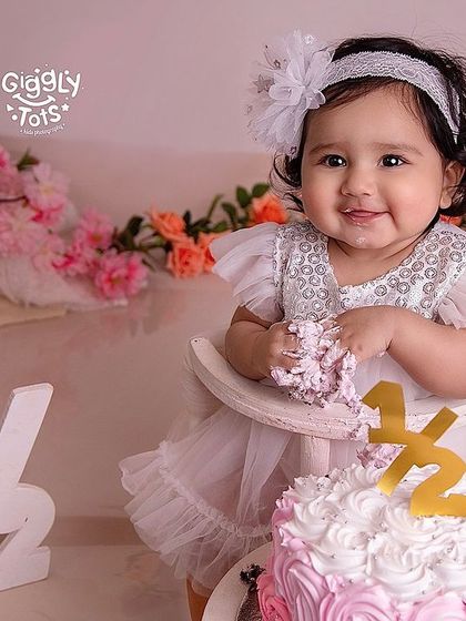 Halfway to one! A six-month cake smash is a wonderful way to mark this adorable milestone. Her smile says it all.