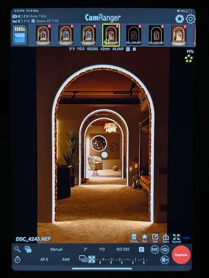 A behind-the-scenes shot from our photoshoot, capturing the iconic arches on camera. This view from the monitor shows how we worked to get the perfect angle, highlighting the layered perspective and the warm, inviting glow of the integrated lighting.