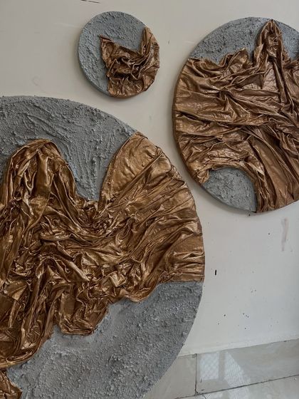 The full set of three circular artworks for the Dubai residence. The different sizes create a dynamic arrangement on the wall, like planets or celestial bodies.