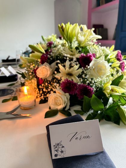 Personalized details make an event truly special. For this 28th birthday, I arranged for custom place cards to complement the lush floral centerpiece and candlelit table.