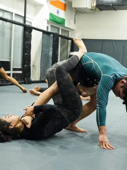 Students practice passing the open guard in a No-Gi class. This scenario is common in both sport BJJ and MMA, and we drill it relentlessly.