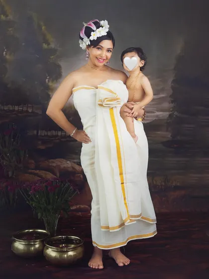 A proud mother with her son. This traditional portrait not only celebrates her pregnancy but also the special bond she shares with her older child.