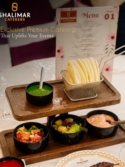 Our exclusive premium catering uplifts your events. This tiered wooden platter elegantly presents a variety of dips and salads alongside crispy potato snacks, perfect for table service.