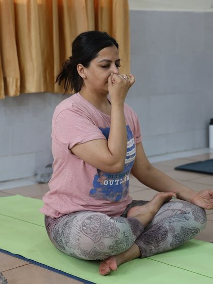 A woman practices pranayama, a technique that pacifies agitated energy and cools the brain. It is a powerful tool for rest and relaxation.