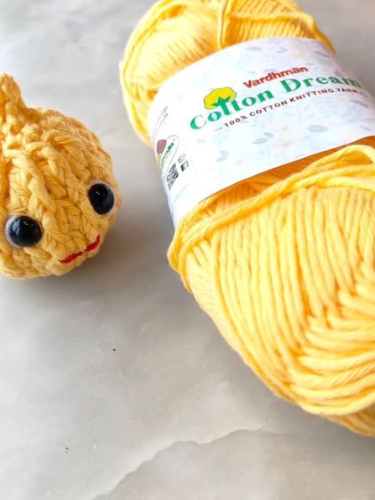 The Modak plushie next to the Vardhman cotton yarn I used to make it.