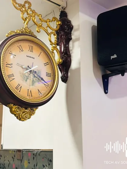 A Polk ES10 speaker wall-mounted for a surround sound setup. Its compact design and mounting options make it easy to create an immersive audio experience in any room.