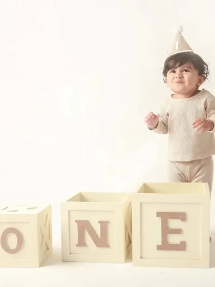 Standing proud with his 'ONE' blocks, this little man is ready to take on his second year.