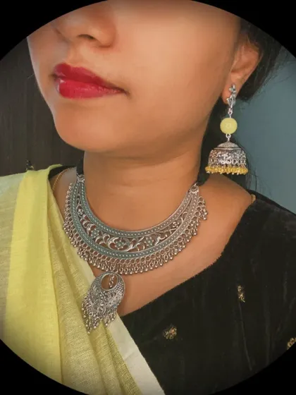 A close-up of the yellow-themed festive look. You can see the detail on the oxidised choker necklace and how beautifully it pairs with the yellow beaded jhumkas.