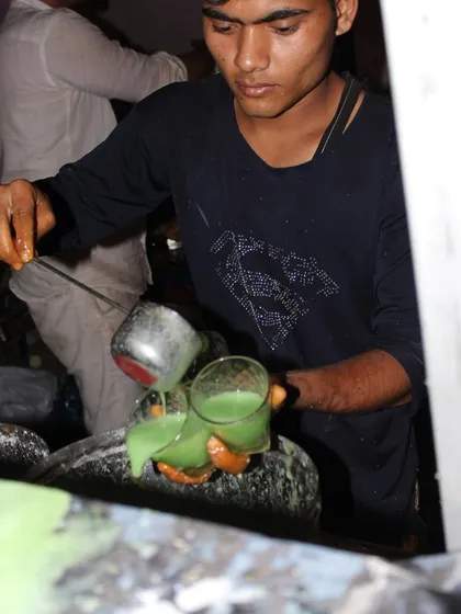 A staff member carefully preparing a refreshing green juice. Our juice bar is a popular feature, offering a healthy and tasty beverage option for guests.