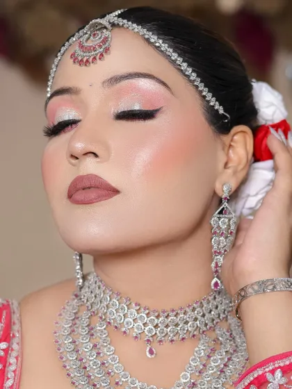 A close-up with eyes closed, showcasing the beautiful blend of pink and silver eyeshadows.