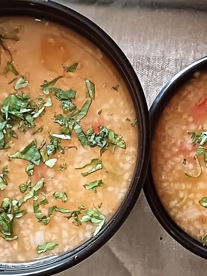Two bowls of my nutritious Vegetable Daliya (savory broken wheat porridge). It's packed with finely chopped vegetables and is a very wholesome meal.
