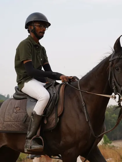 A duplicate of 48, a rider on a black horse enjoying the outdoor trek.