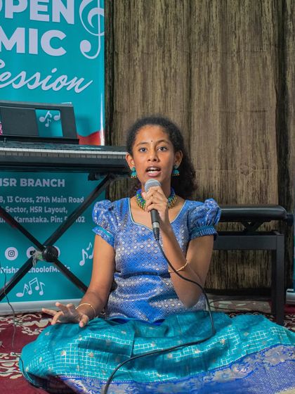 A student singing a Carnatic piece in traditional attire at our HSR open mic. I encourage students to embrace the cultural aspects of the music they learn.
