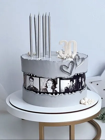 I love bringing your stories to life, and this custom 30th birthday cake was a special one. The sleek grey frosting and tall silver candles create a modern look, while the film strip of black and white photos adds a touch of nostalgia. It’s a perfect way to celebrate a major milestone.