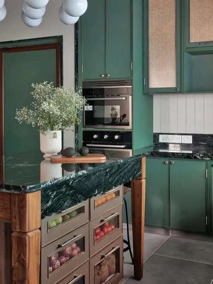 The island in this kitchen is a workhorse, featuring deep drawers with mesh fronts for ventilated storage of fruits and vegetables. It’s a practical solution that is also a beautiful design element.