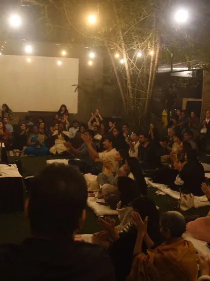 A wide angle shot of the audience and performers at The Courtyard, showing the full baithak atmosphere.
