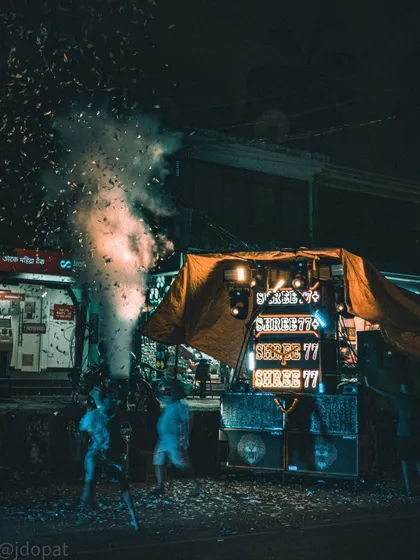 A crowd dances in a shower of confetti in front of a large sound system during the Narakasura celebrations in Goa.