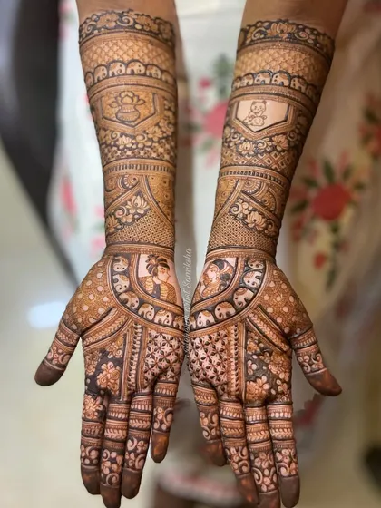 This bridal design features portraits of a couple, surrounded by elephants and traditional patterns. It's a beautiful blend of personalization and classic bridal art.
