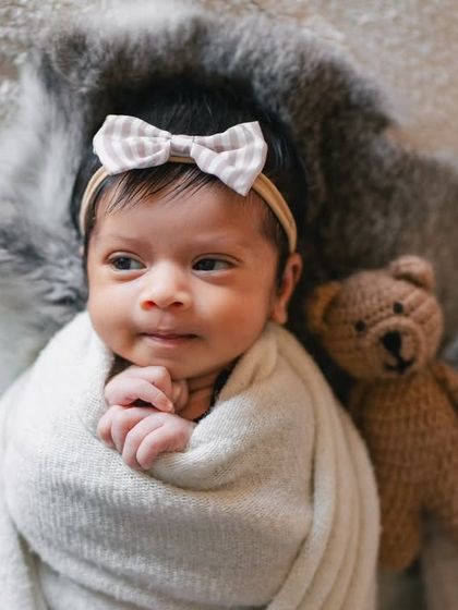 This awake and alert newborn girl looks right at the camera. I work with your baby's mood, capturing their bright-eyed curiosity just as beautifully as their sleepy moments.