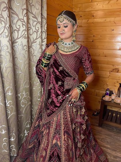 Showcasing the royal elegance of this bride's reception look, with soft glam makeup that complements her rich velvet lehenga.