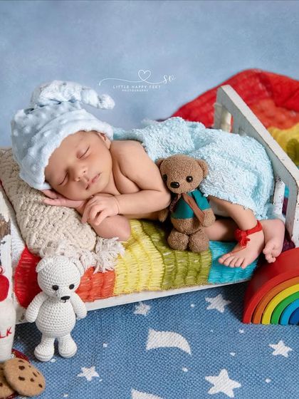 Dreaming in a rainbow bed. This colorful and cheerful setup, complete with milk and cookies, is perfect for celebrating your rainbow baby or just for a bright and happy portrait.