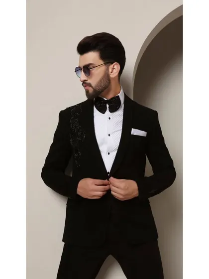 The Galaxy tuxedo, designed for the modern man. The asymmetric cosmic-inspired beadwork on the shoulder adds a touch of futuristic elegance to the classic black-tie silhouette.