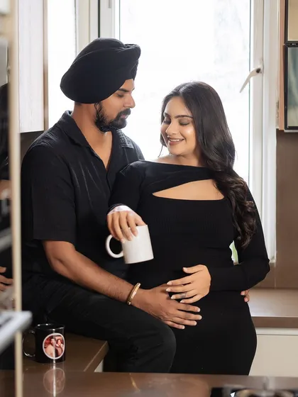 Another angle of the couple's coffee moment, this shot focuses on their loving gaze and the gentle way they hold each other, telling a story of partnership and shared dreams.
