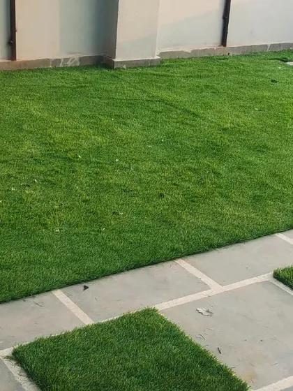 A clean, modern look is achieved by seamlessly integrating our artificial turf with natural stone pavers. This combination creates defined pathways and zones while maintaining a cohesive and polished garden design that requires minimal upkeep.