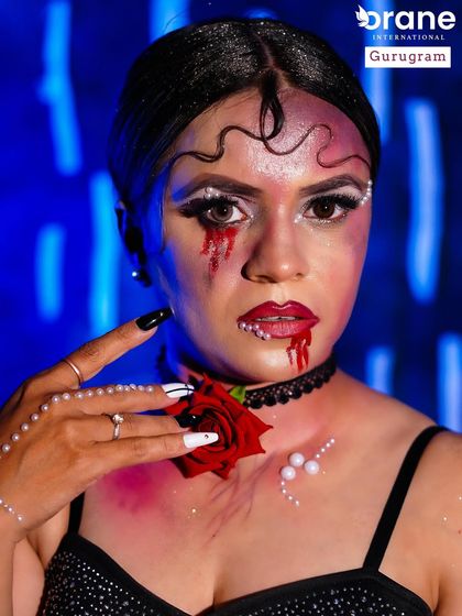 The addition of a red rose and pearl details adds a touch of gothic romance to this evil glam look. I encourage students to use props and accessories to enhance their concepts.