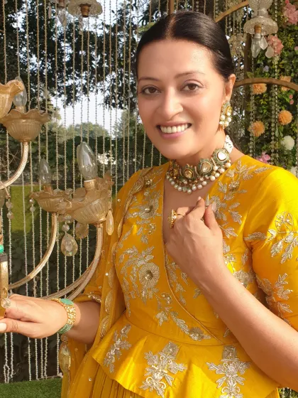 A bright and festive look for a Baisakhi celebration. This yellow peplum-style kurta with intricate silver embroidery is paired with a sharara, creating a look that is traditional yet contemporary. The statement choker adds a touch of modern bridal inspiration.
