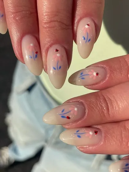 Dainty, hand-painted wildflowers on a sheer nude base. The delicate stems and tiny details give this manicure a whimsical, cottage-core feel.