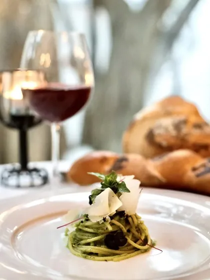 A perfect mid-week mood booster: our spaghetti al pesto, made with fresh basil and olive dust, served with rustic bread.