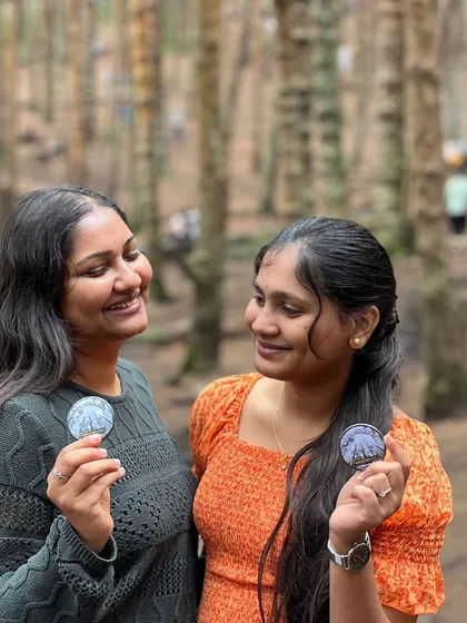Two friends showing off their Kodaikanal badges.