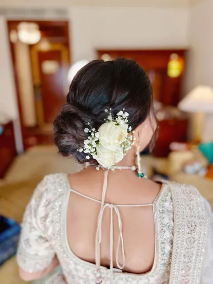 A detailed look at this bride's elegant wedding style, from her flawless makeup to her intricate floral bun.