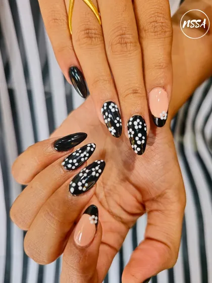 Another look at this perfectly executed black and white floral polka dot design, showing the consistency across all nails.