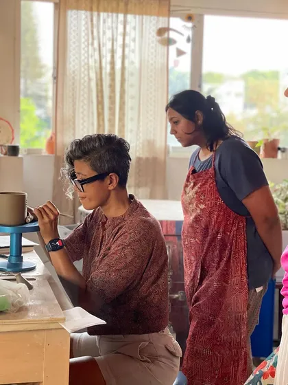 A moment of focused instruction, as I demonstrate a trimming technique to a student, sharing the finer details of the craft.